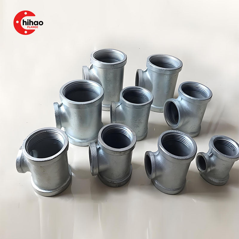 Real photo of galvanized malleable iron threaded tees, including equal and reducing types with female connections, available in various sizes for plumbing, gas, and fire protection systems.