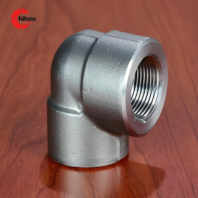 Real-life shot of forged 90-degree threaded elbow, showing female NPT inner thread details, carbon steel pipe fitting for high-pressure industrial and fire suppression pipelines.